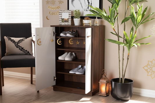 Wooden shoe cabinet with open door displaying shoes, next to a plant and chair.